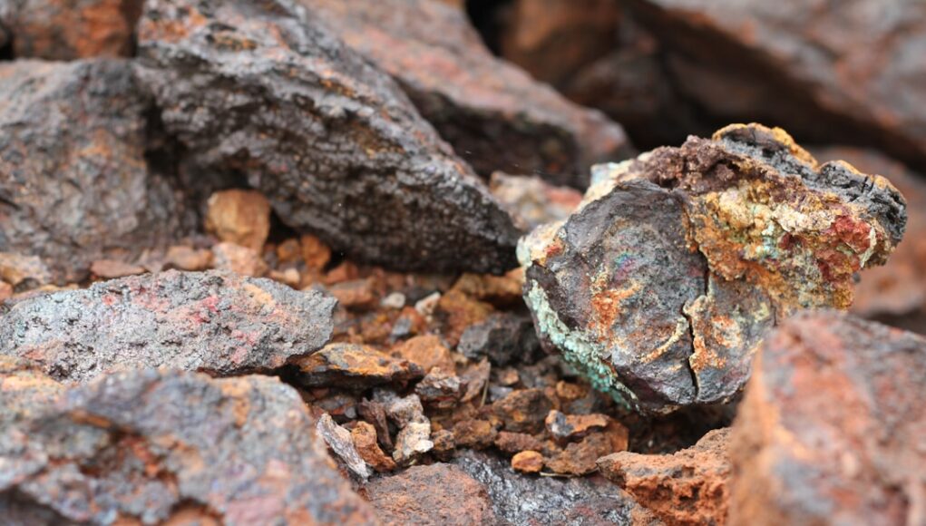 Ore containing copper, cobalt and nickel at the undeveloped Andover project in Western Australia. a close up of a rock with lichen on it