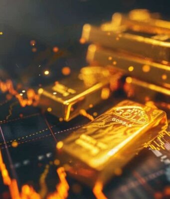 Gold: Hier könnte bald Größeres passieren! Pile of gold bars on a dark surface with glowing financial chart lines in the background.