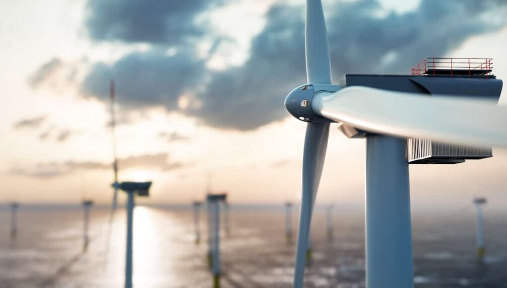 RWE-Aktie-Kursdynamik-geht-zurueck-–-was-ist-jetzt-ratsam.jpeg Offshore wind turbine at sunset with calm sea and distant turbines in the background.