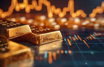 Versamet-Aktie: Geht es nun weiter bergauf? Gold bars resting on a financial trading chart with glowing price lines in the background