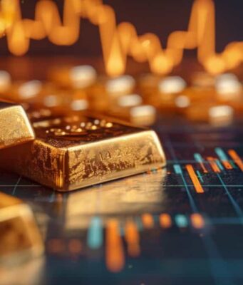 Versamet-Aktie: Geht es nun weiter bergauf? Gold bars resting on a financial trading chart with glowing price lines in the background