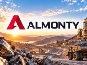 Almonty-Aktie mit -44% – lohnt sich jetzt der Einstieg? Almonty logo over a rock mining site with dump trucks and conveyor belts at sunrise/sunset.