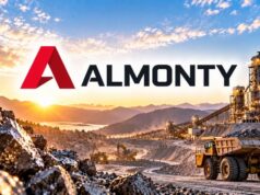 Almonty-Aktie mit -44% – lohnt sich jetzt der Einstieg? Almonty logo over a rock mining site with dump trucks and conveyor belts at sunrise/sunset.