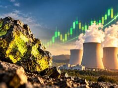 Cameco-Aktie stark gefallen – Anleger wittern neue Chancen Rugged rocks in the foreground with a power-plant cooling towers and rising green stock-chart line in the sky, signaling growing energy investment.