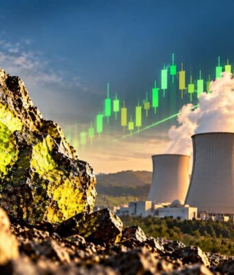 Cameco-Aktie stark gefallen – Anleger wittern neue Chancen Rugged rocks in the foreground with a power-plant cooling towers and rising green stock-chart line in the sky, signaling growing energy investment.