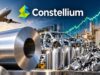 Constellium: Diese Aluminium-Aktie ist jetzt ein Top-Pick Constellium branding over an industrial aluminum recycling scene: large metal coil, skeletal car frame, stacked cans, and a recycling symbol in the foreground and factory backdrop.